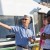 Marine Division Director Paul Brodeur gestures as he directs two people on the Seattle Pier 50 water taxi dock, with the water taxi in the background.