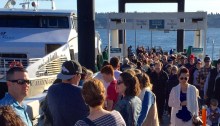 Pier 50 with many passengers waiting to board as others exit the Water Taxi.
