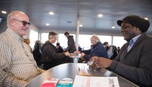 Mike Sudduth, left, plays a game of cribbage with Richard Franklin, right, as another game of cribbage takes place at the table next to them aboard the MV Sally Fox. Sudduth donated the specially inscribed boards as a way to honor his friend, Sally Fox, who was an advocate for passenger-only ferry service to Vashon Island and the vessel's namesake.
