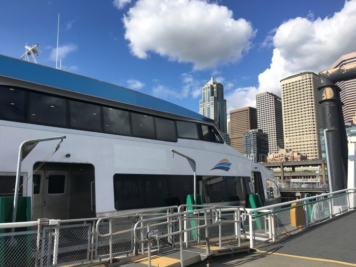 The MV Sally Fox awaits passengers at Pier 50 with the Seattle skyline in the background.