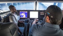 Students with Woodland Park Zoo's Summer Youth Climate Action Network visit the wheelhouse of a King County Water Taxi vessel.