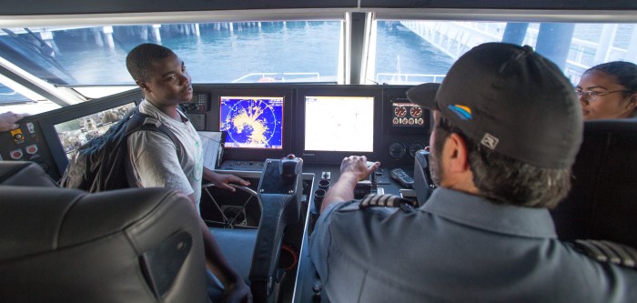 Students with Woodland Park Zoo's Summer Youth Climate Action Network visit the wheelhouse of a King County Water Taxi vessel.