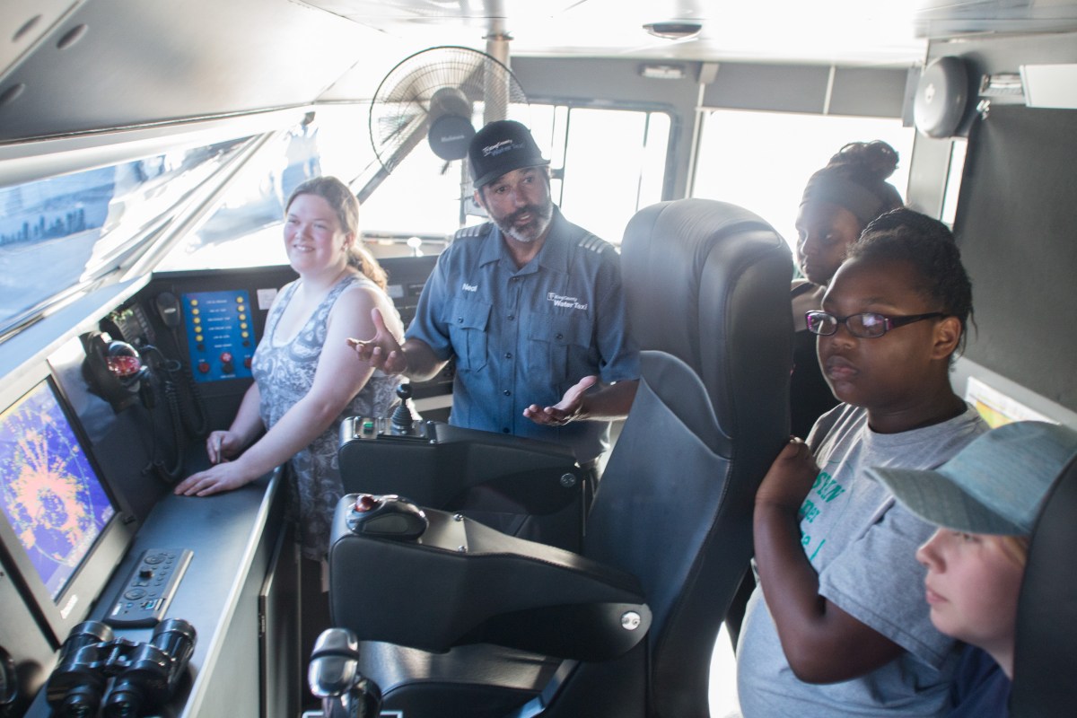 Students with Woodland Park Zoo's Summer Youth Climate Action Network visit the wheelhouse of a King County Water Taxi vessel.