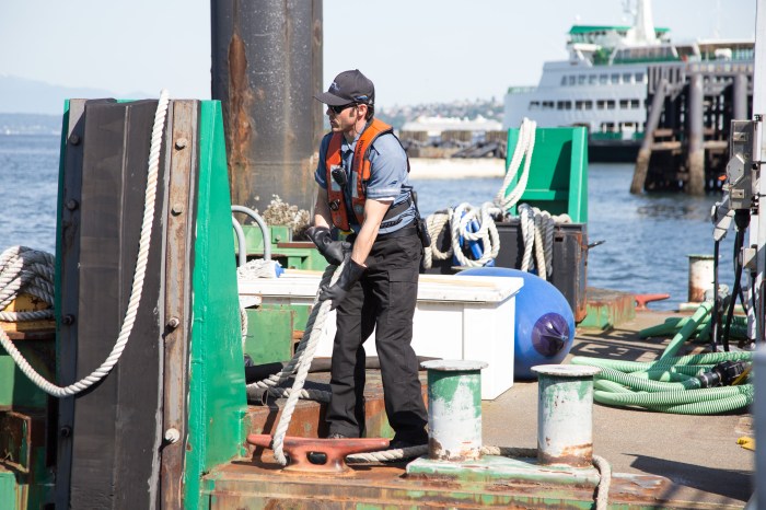 A dekhand with King County Water Taxi works at Pier 50.