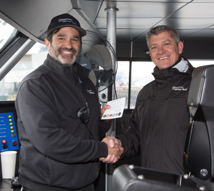 Captain Neal Amaral receives his Veterans Day pin from Ron Panzero, Marine Operations and Maintenance Manager for King County Water Taxi.