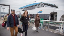 Riders from Vashon Island disembark the MV Sally Fox in Seattle.