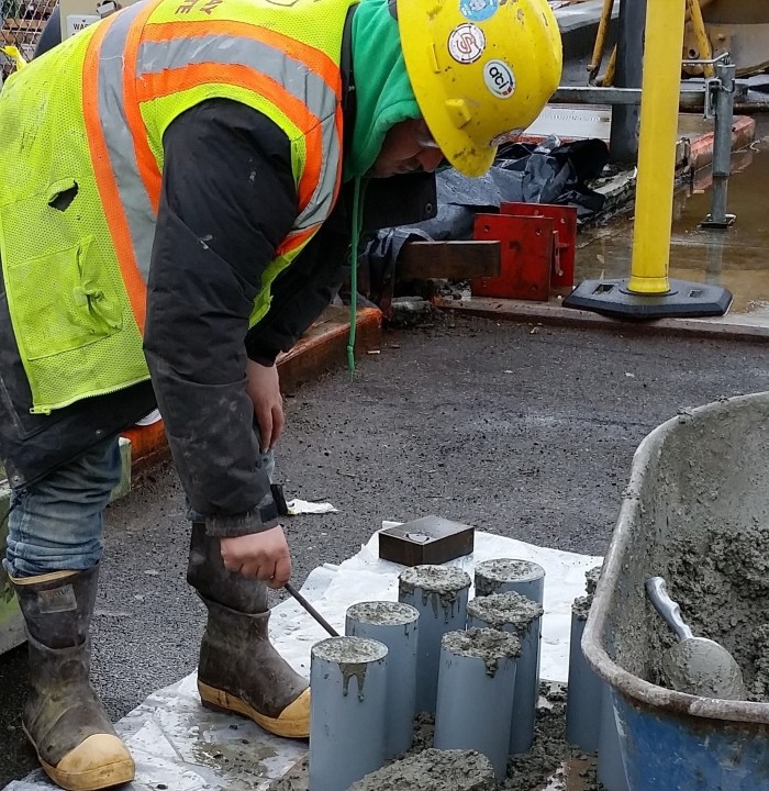 A worker adjusts recently poured concrete on top of a piling at King County Water Taxi's future Passenger Only Ferry (POF) facility at Colman Dock. The procress, known as capping, will help connect the piles to the trestle and passenger deck of the facility.