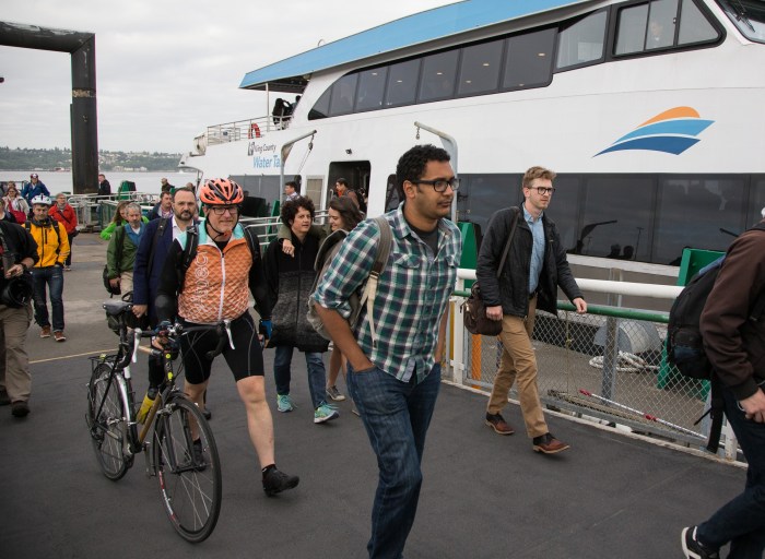 A group of riders from Vashon Island - including a bicylist - disembark the MV Sally Fox after it arrives at Pier 52 on the Seattle waterfront.