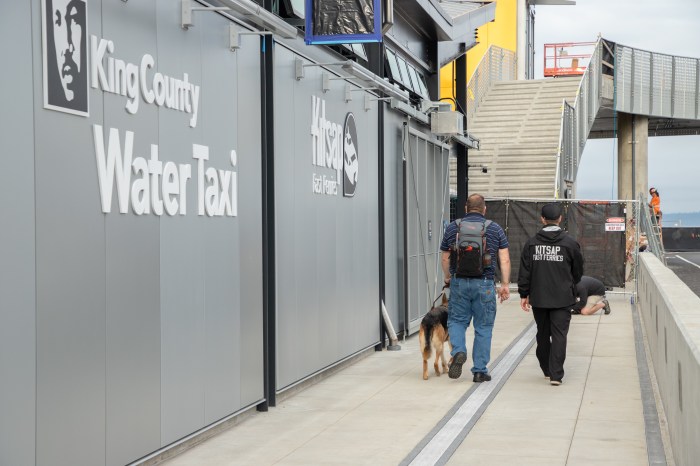 A man with a visual impairment walks along the new tactile path with a Kitsap Fast Ferries staff member into the new passenger-only ferry facility.