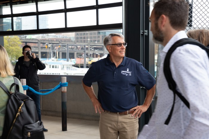 Marine Division Director Paul Brodeur greeting passengers disembarking from the Water Taxi