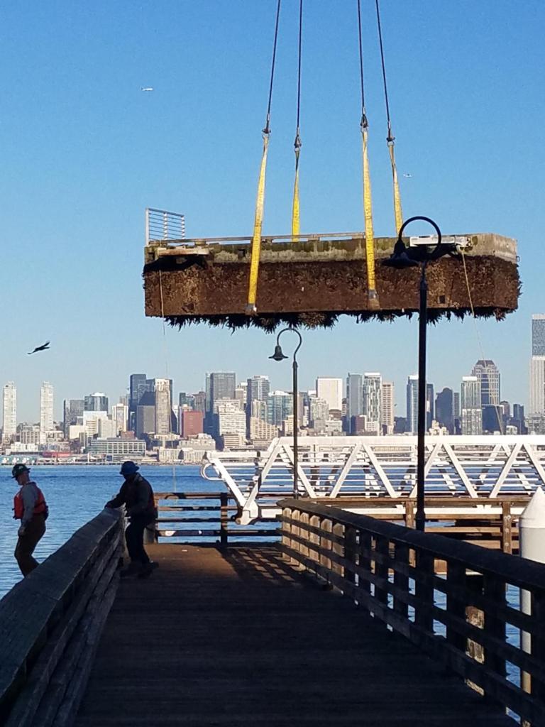 A crane removes the old dock