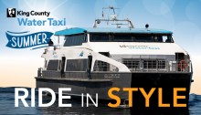 Water Taxi Sally Fox sailing with the words "Ride in Style" and the bottom and the Water Taxi logo in the top right corner