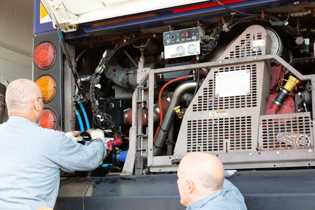 Vehicle maintenance staff making sure a bus is ready to go!