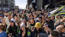 Dense crowd of Seahawks fans in downtown Seattle on victory parade day.